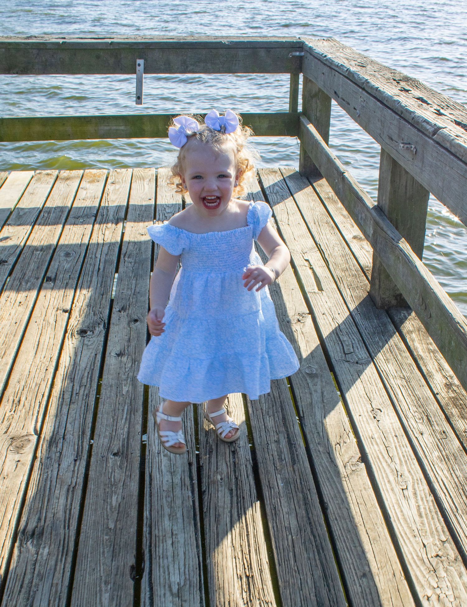 Child portrait photographer Hinesville GA, blue dress kid playing dock water — The Quiet Lens Studio