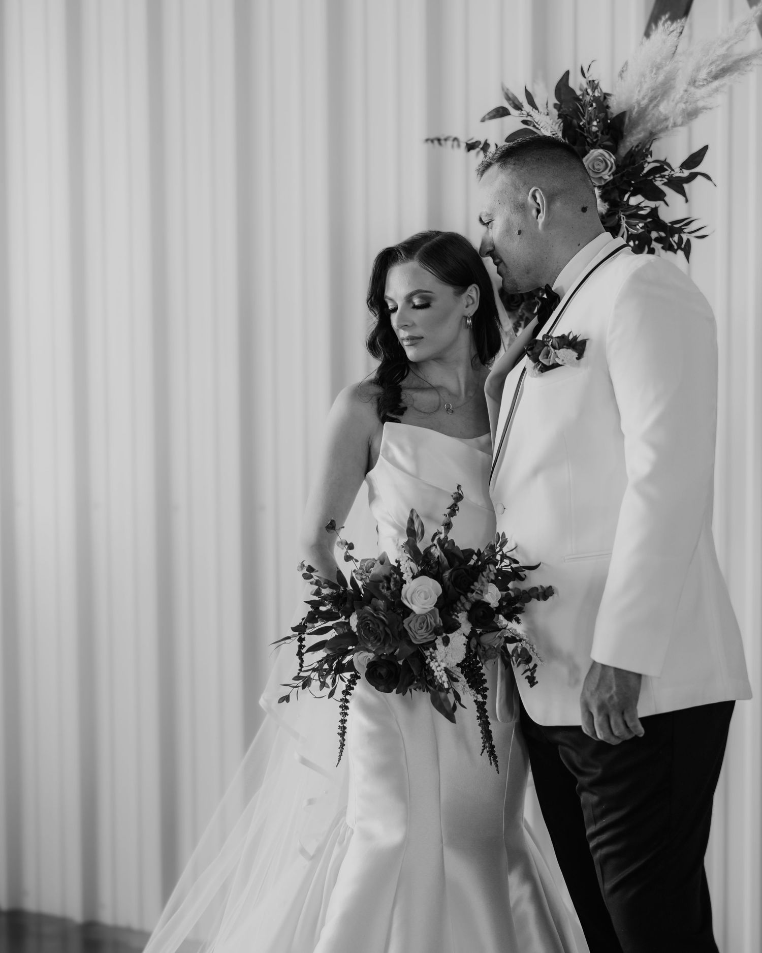 Black and white wedding portraits showing intimate moments between couple.