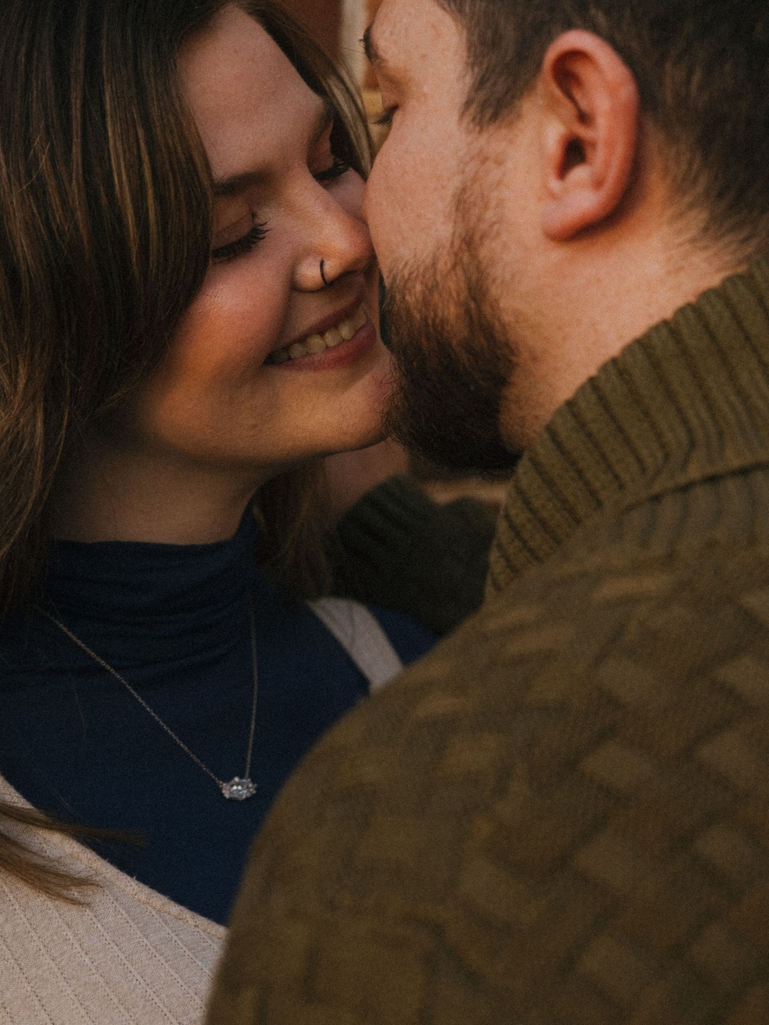 Close-up of a tender romantic moment between a couple in casual attire.