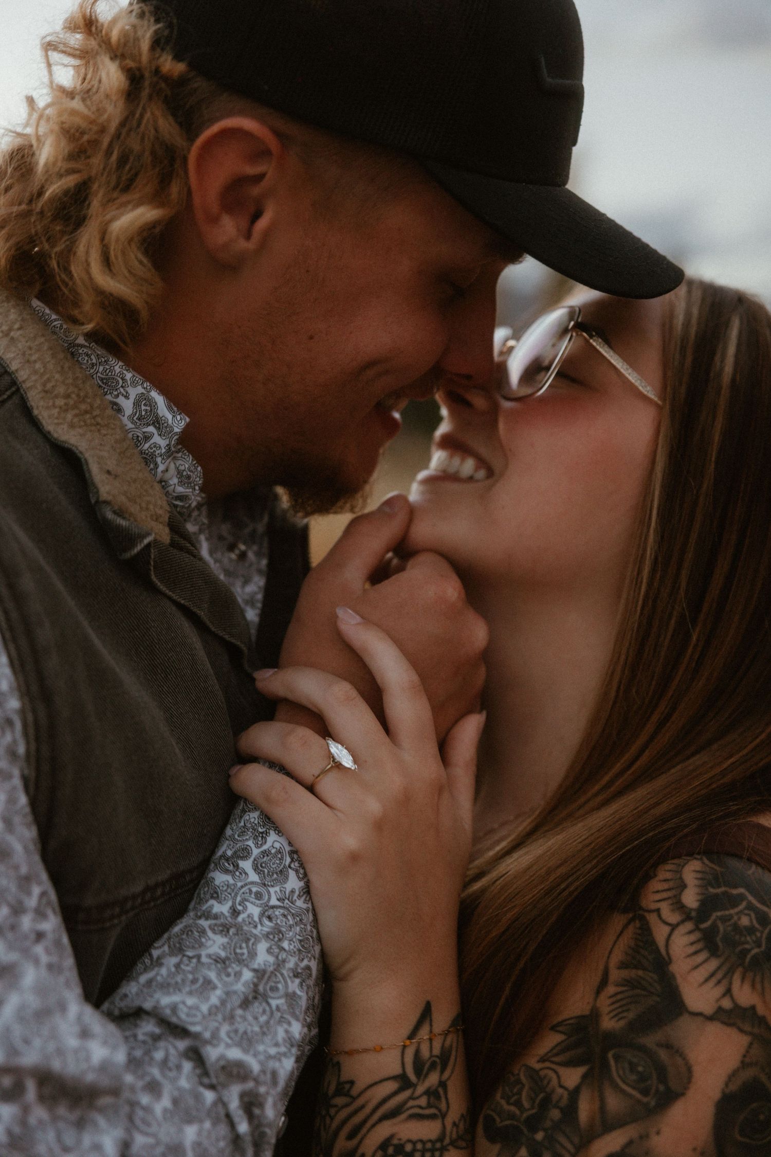 Intimate close-up portrait showing tender romantic connection against soft lighting.
