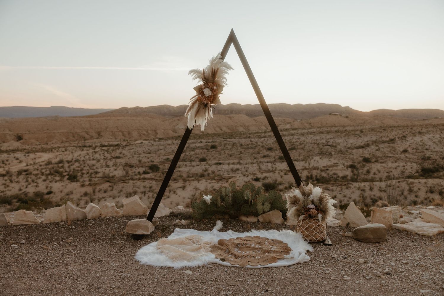 A sequence of desert landscape photos showing a wooden tripod structure over a puddle in arid terrain at sunset.