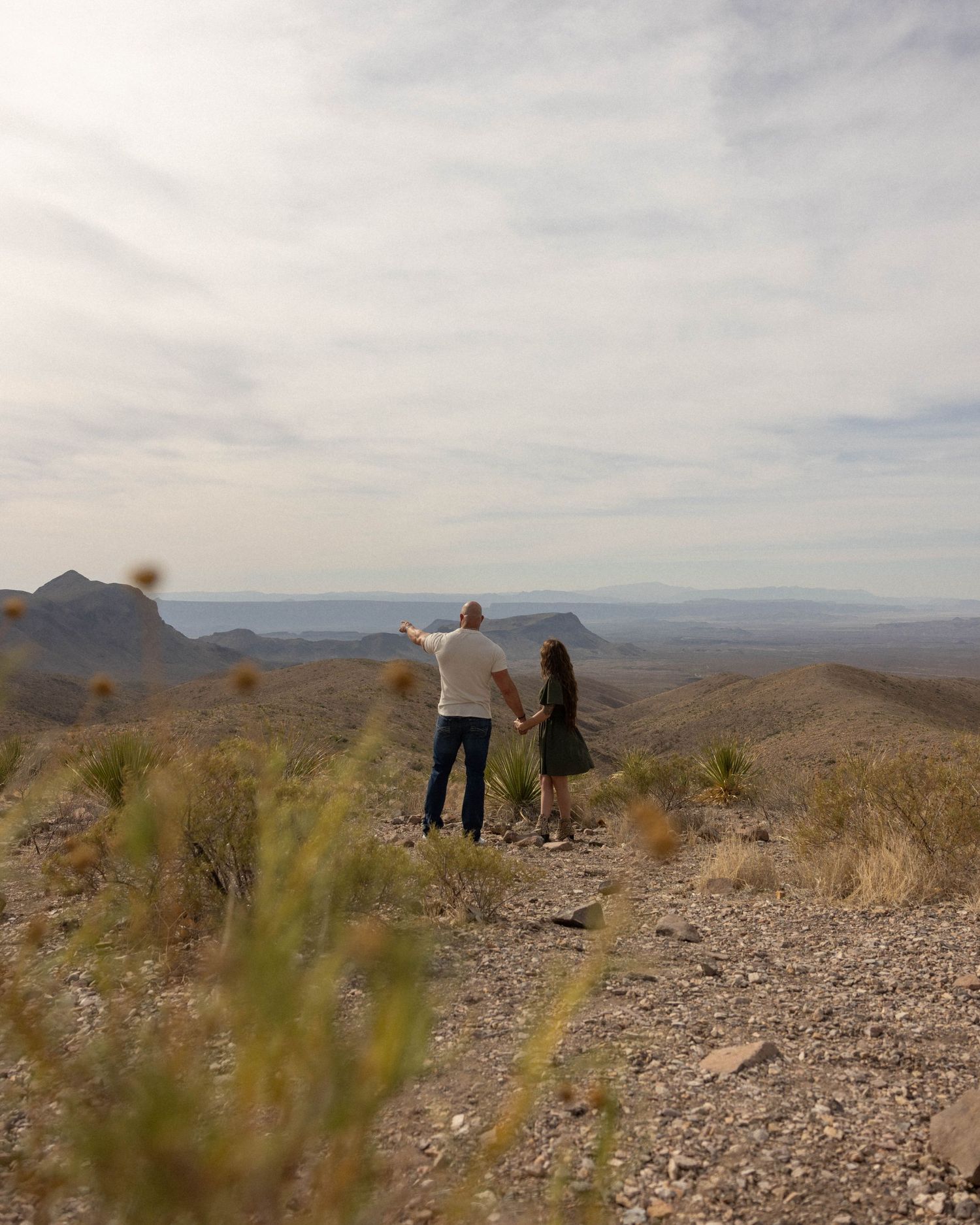 Desert landscape with mountains and rocky terrain stretching into the distance.