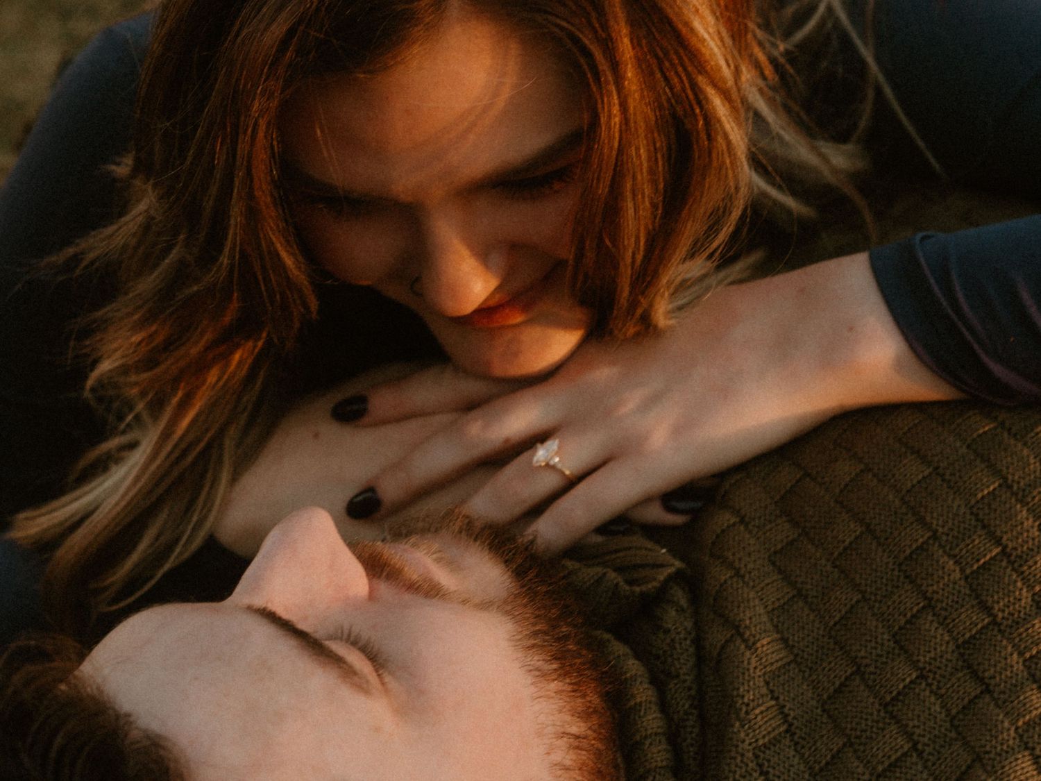 Artistic close up shot capturing tender moment in warm dramatic lighting.