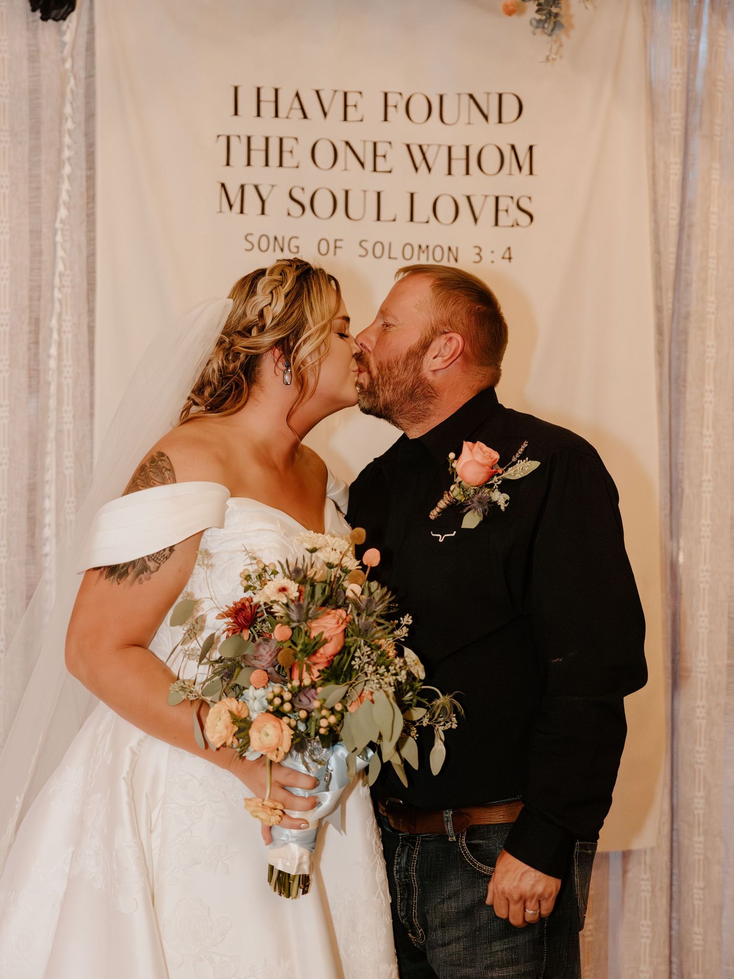 Intimate wedding moment captured against backdrop with romantic text overlay.
