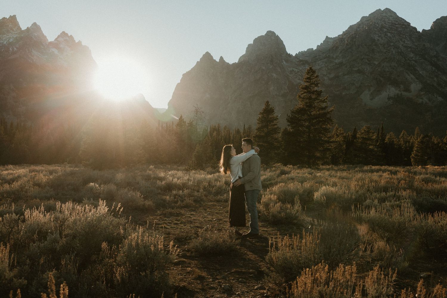 Majestic mountain landscape at sunset with rugged peaks and golden light.