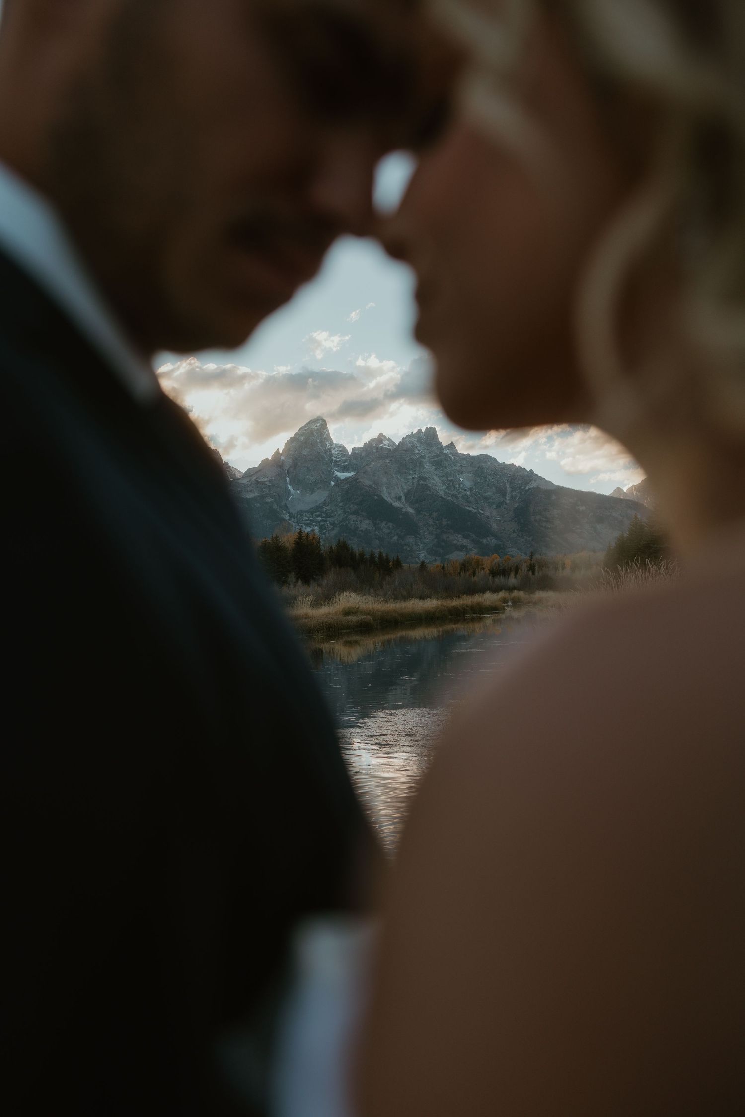 Mountain landscape viewed through a creative framing with lake and peaks visible.