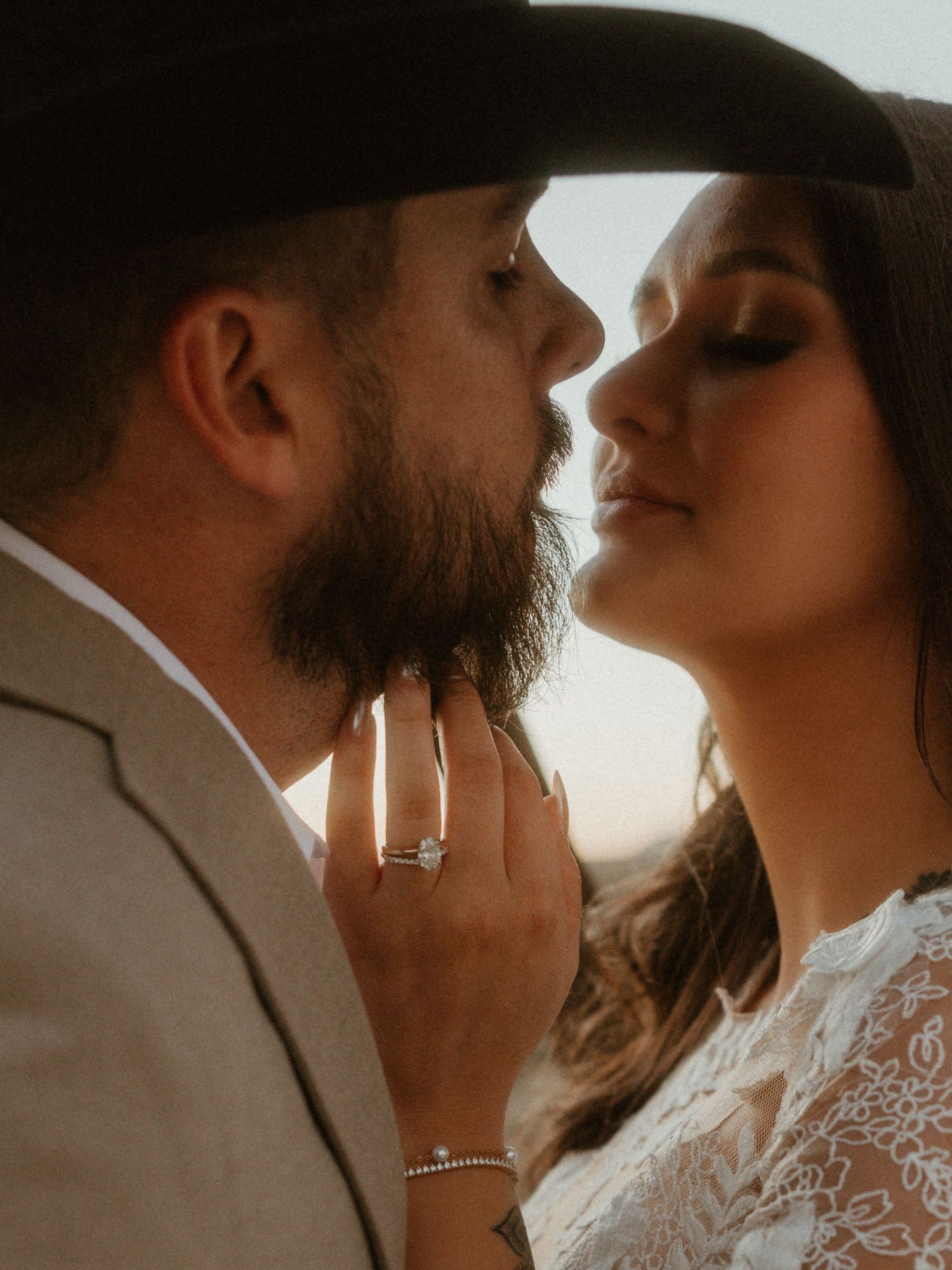 Romantic close-up wedding portrait capturing intimate moments in golden light.