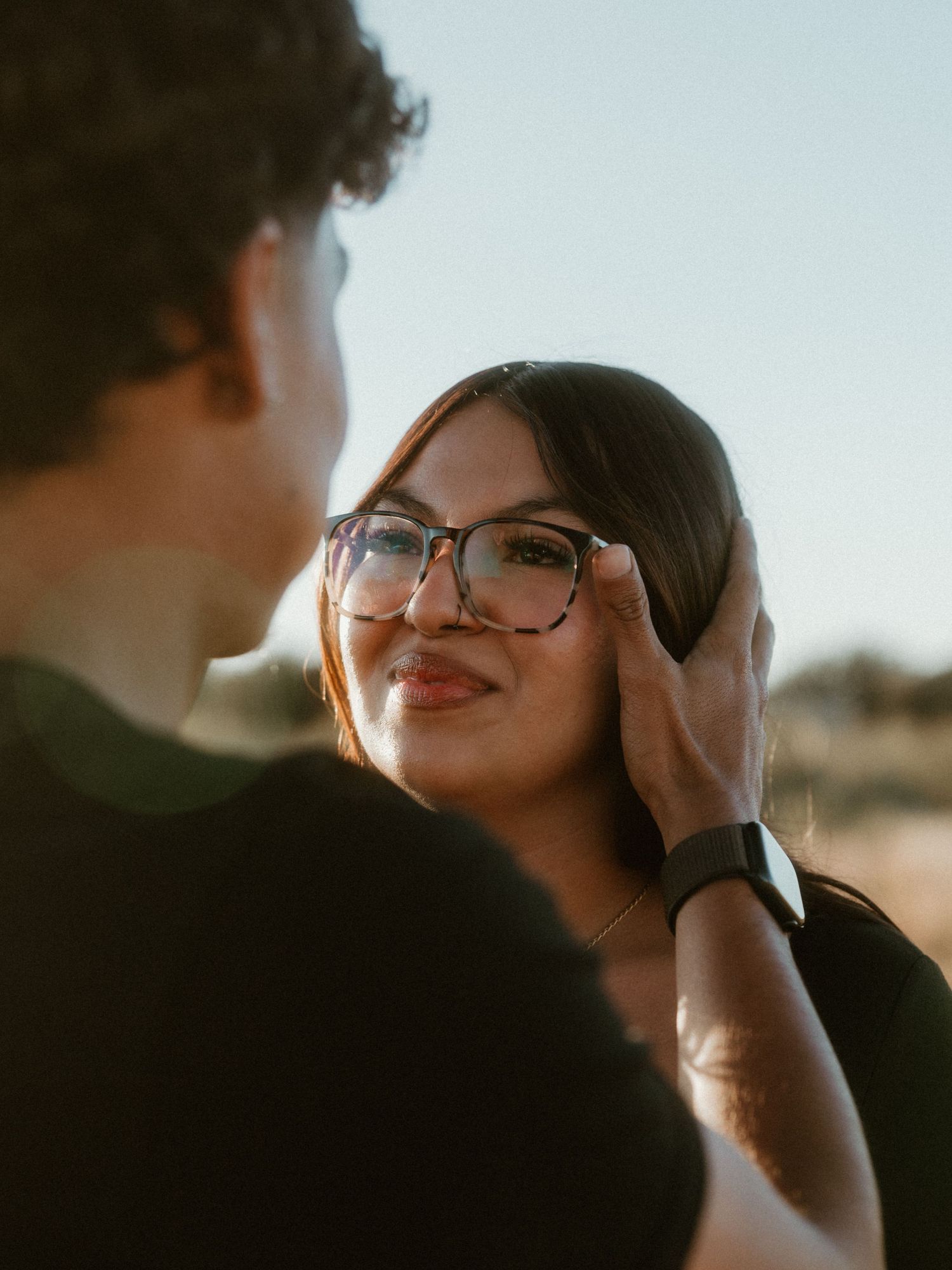 Tender moment between couple during golden hour photoshoot.