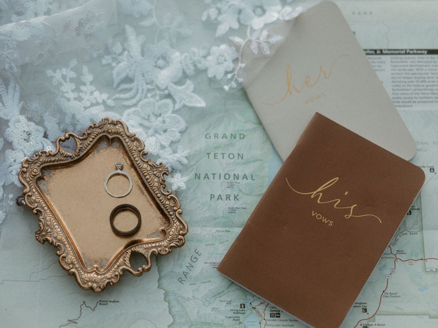 Vintage maps and leather-bound books arranged on a light surface.