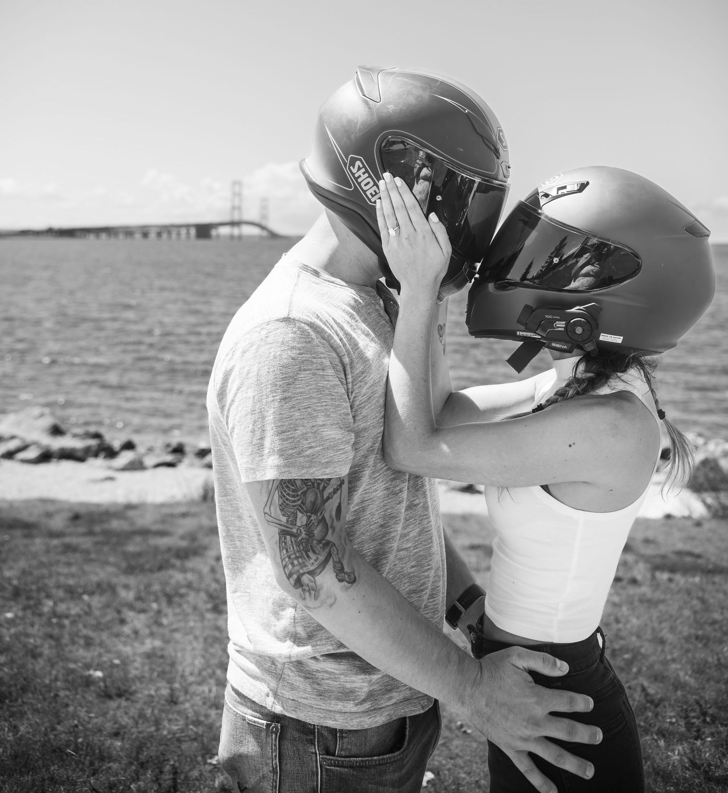 A romantic black and white photo series showing an intimate embrace between two people on a beach.