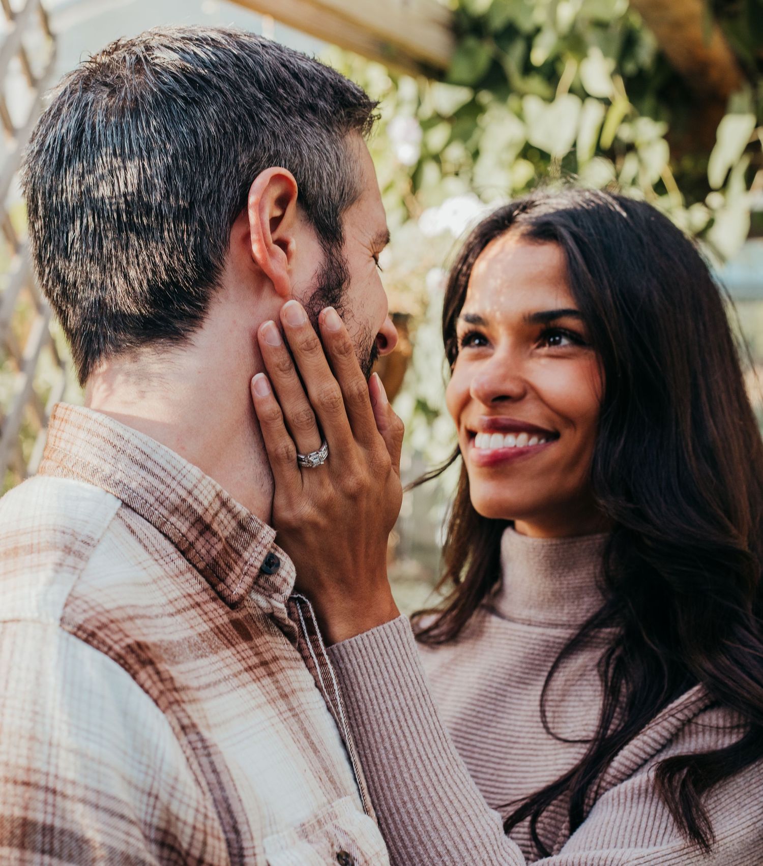 A romantic couple shares intimate moments in a series of outdoor photos with natural lighting and greenery.