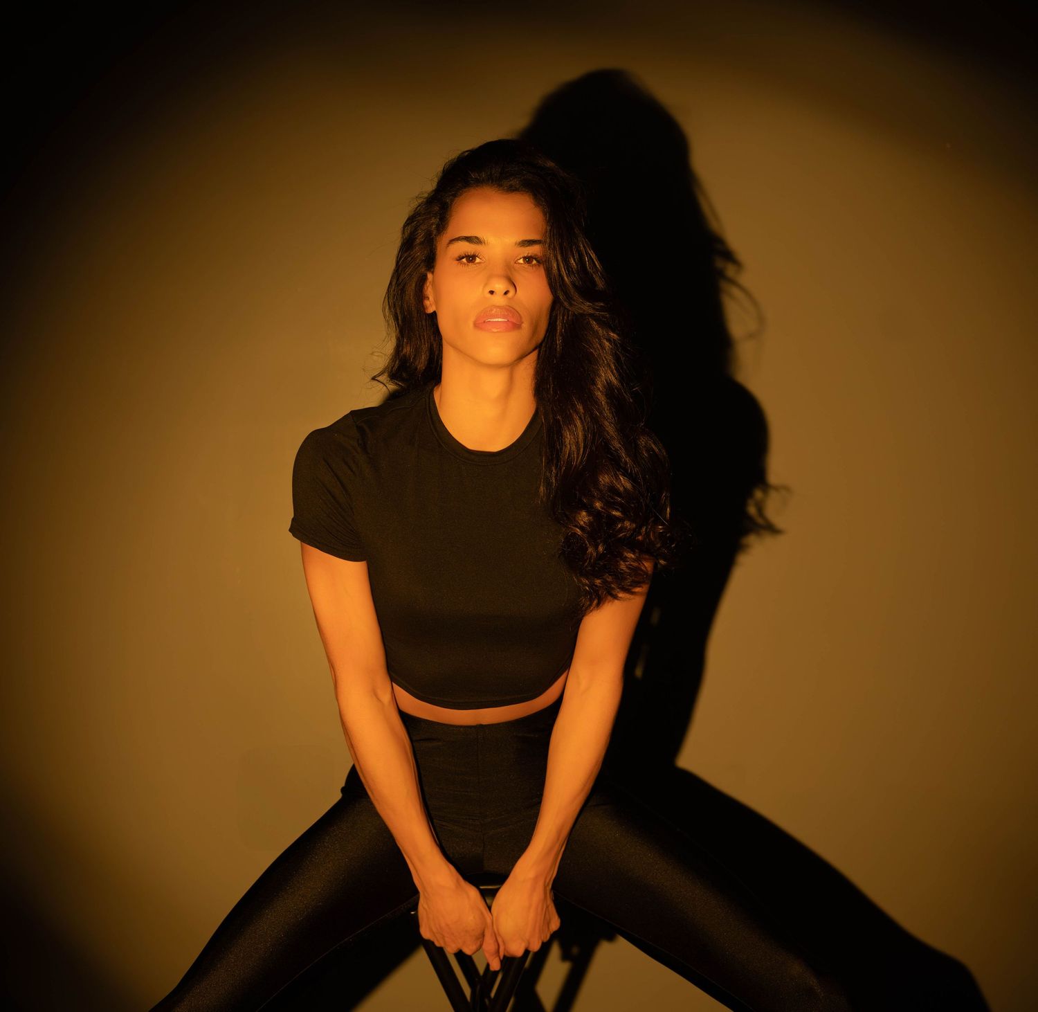 Artistic portrait series showing dramatic lighting and shadows on a person against a dark background in multiple poses.