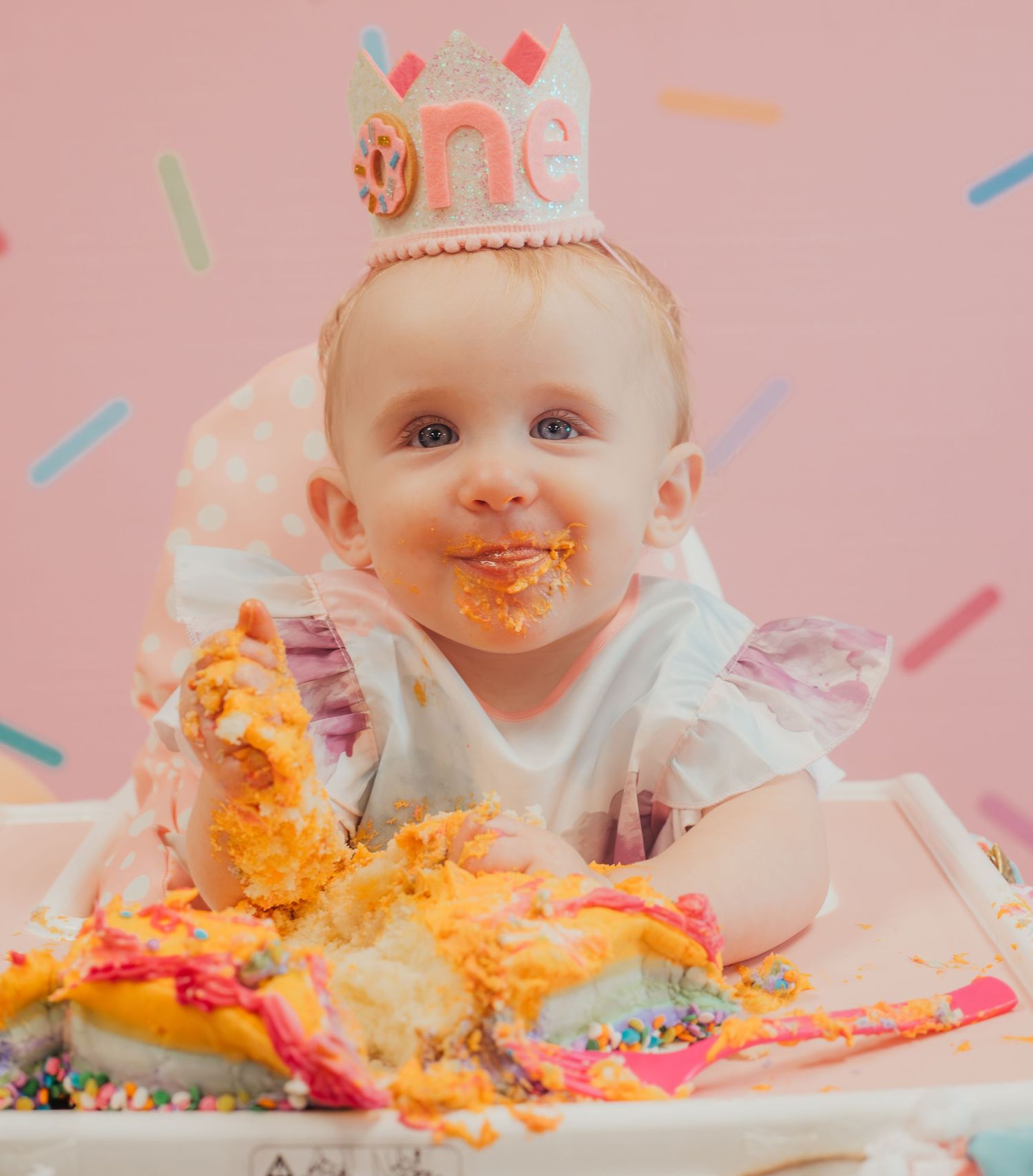 Messy cake smash photo sequence showing colorful frosting getting increasingly smeared during first birthday celebration.