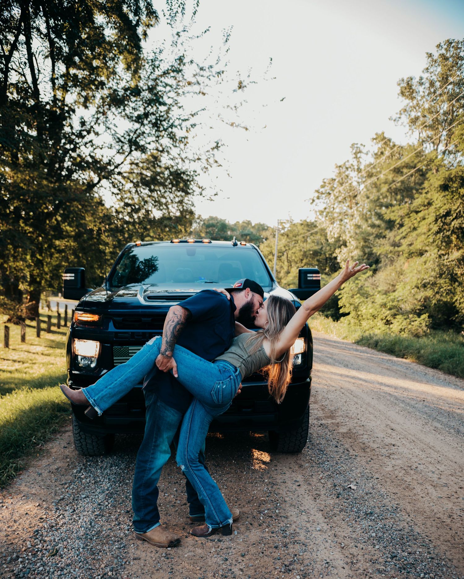 A sequence of photos showing a person in blue clothing falling down on a gravel road next to a black truck.