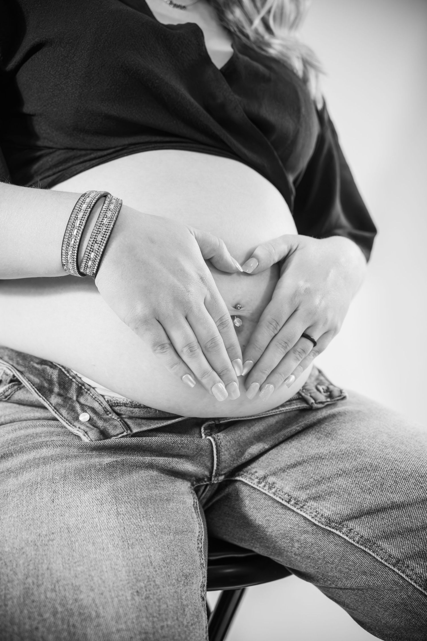 Black and white series showing hands resting on denim jeans in progressive shots.