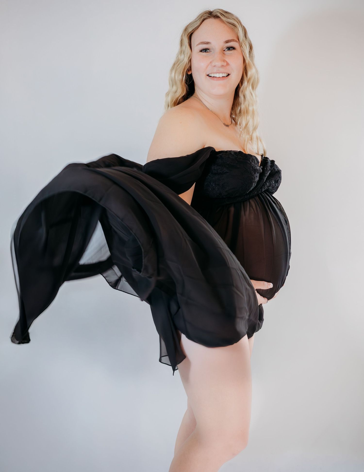A series of artistic portrait photos showing a figure in a black sheer top against a light background.