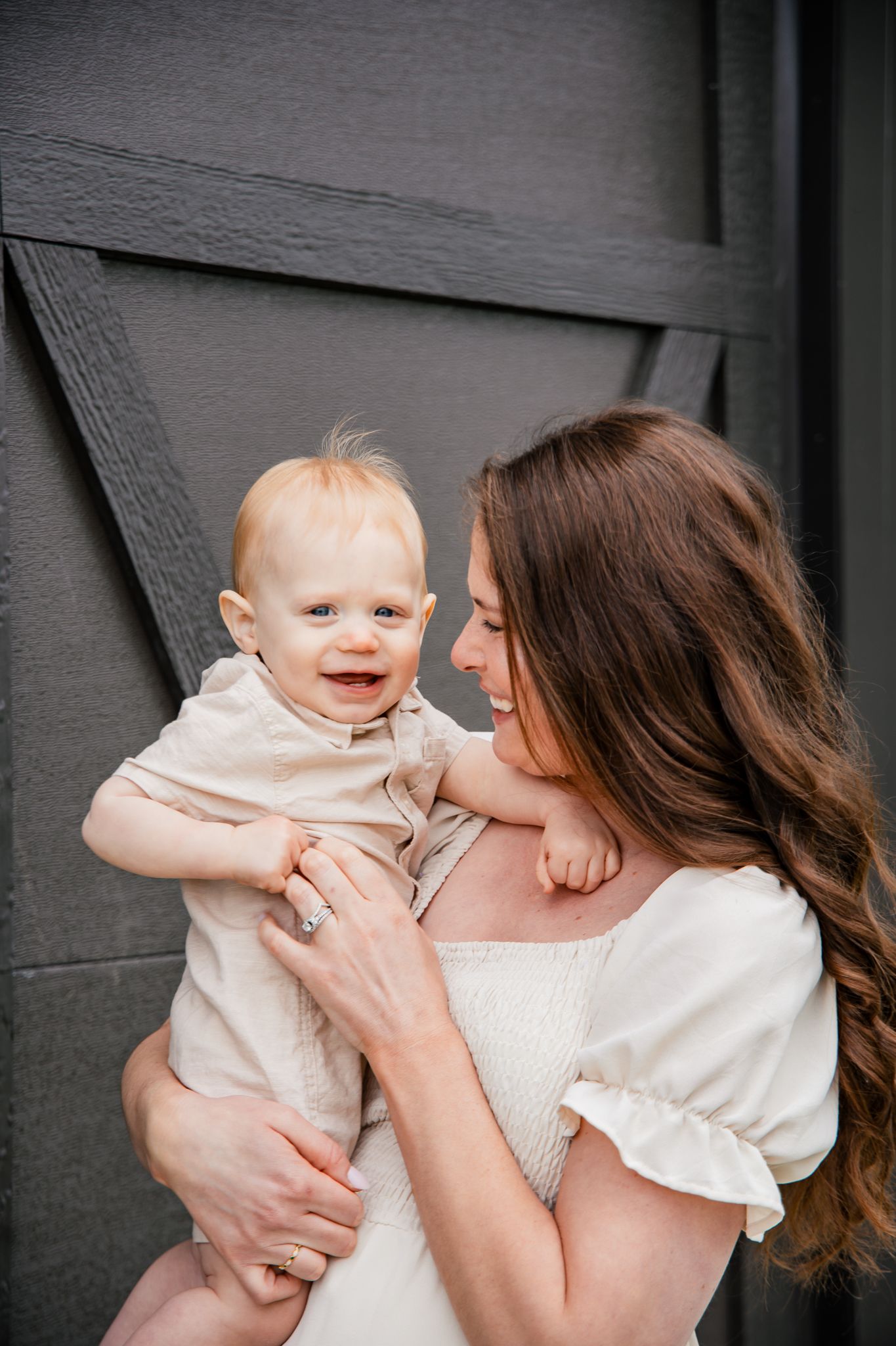light and airy photo of a mother and her young son smiling and laughing