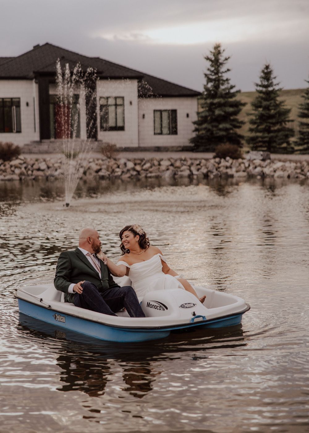 Calgary, Alberta wedding bride and groom in boat on pond