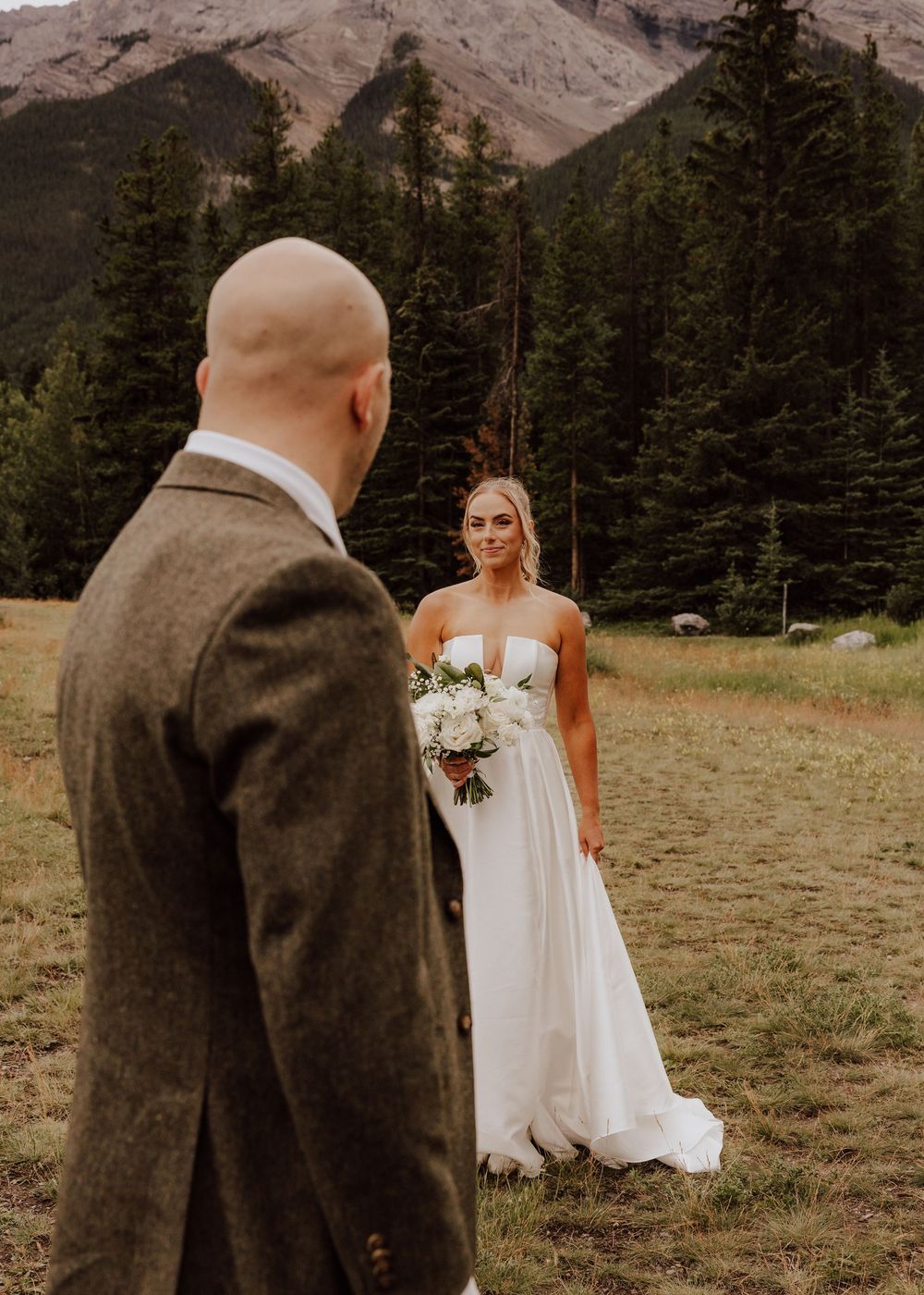Canmore Wedding photos of bride and groom with a mountain background