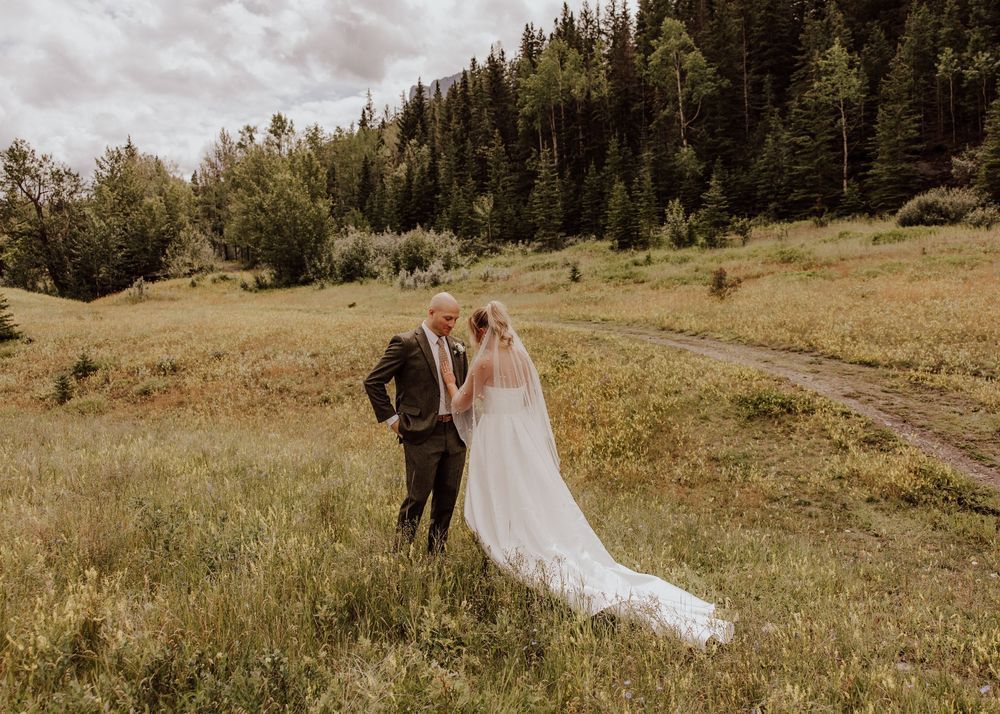 Canmore wedding first look with mountain backdrop