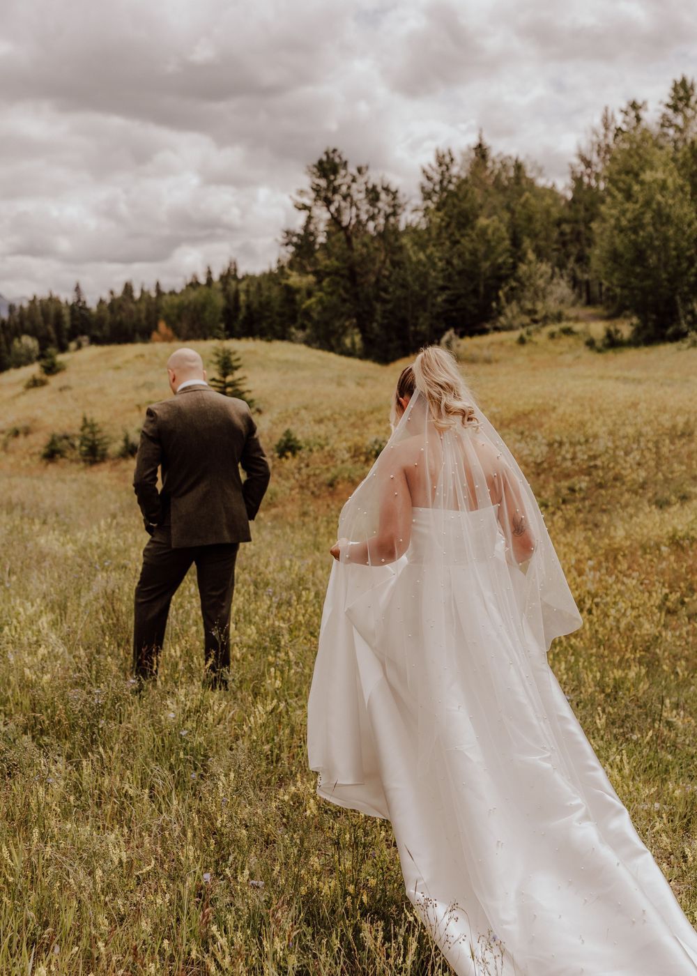Canmore wedding first look with mountain backdrop