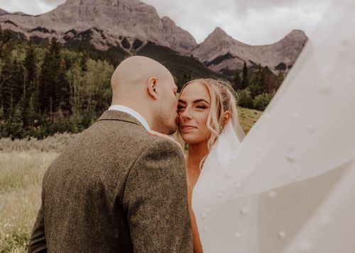 Canmore, Alberta wedding bride and groom with mountain background