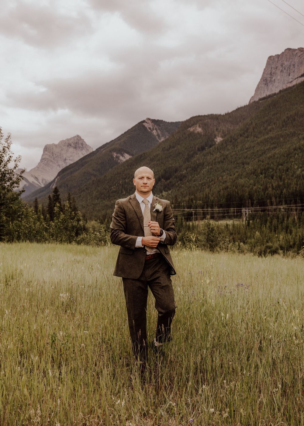 Canmore wedding groom photos with mountain backdrop
