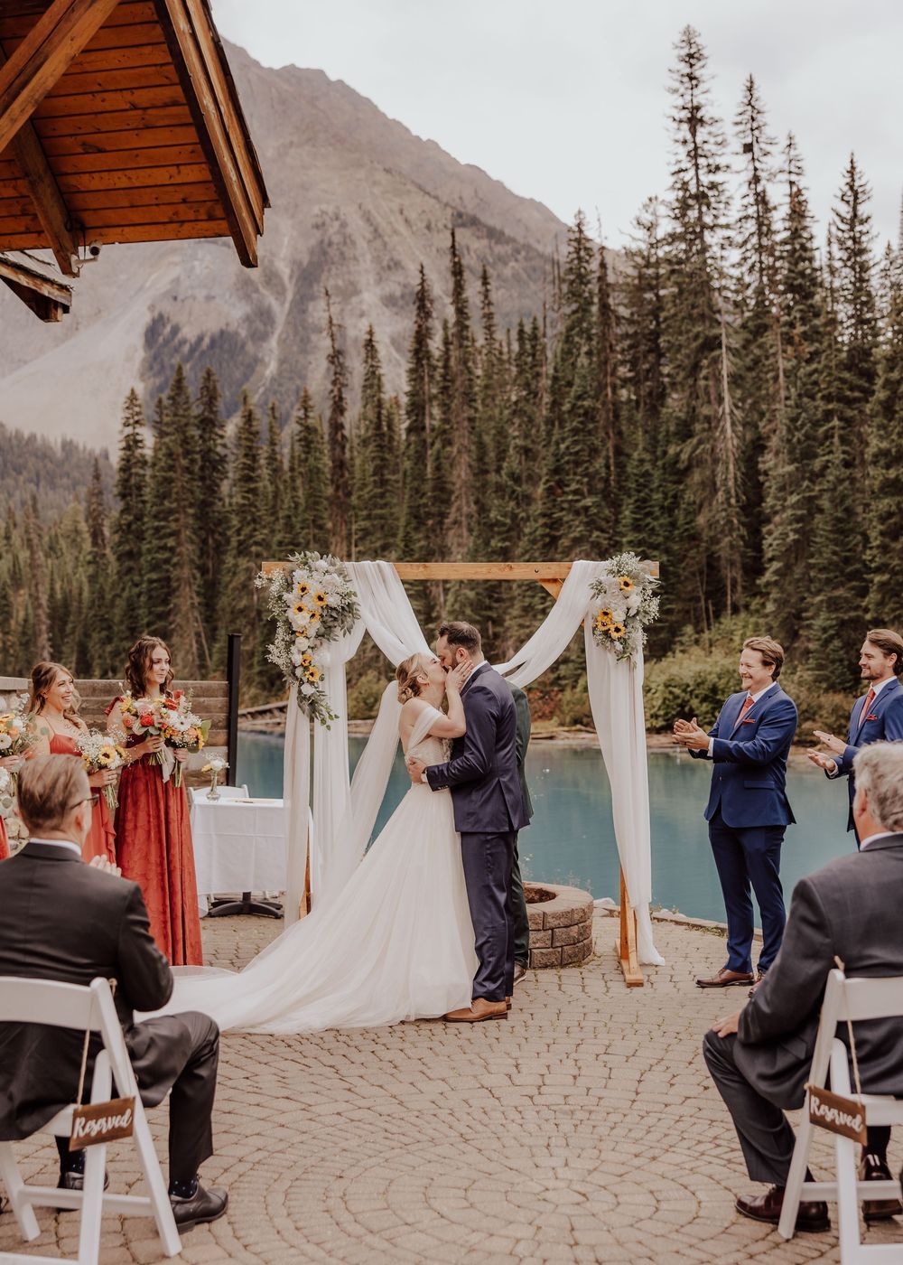 Wedding ceremony at Emerald Lake Lodge in Fields British Columbia first kiss