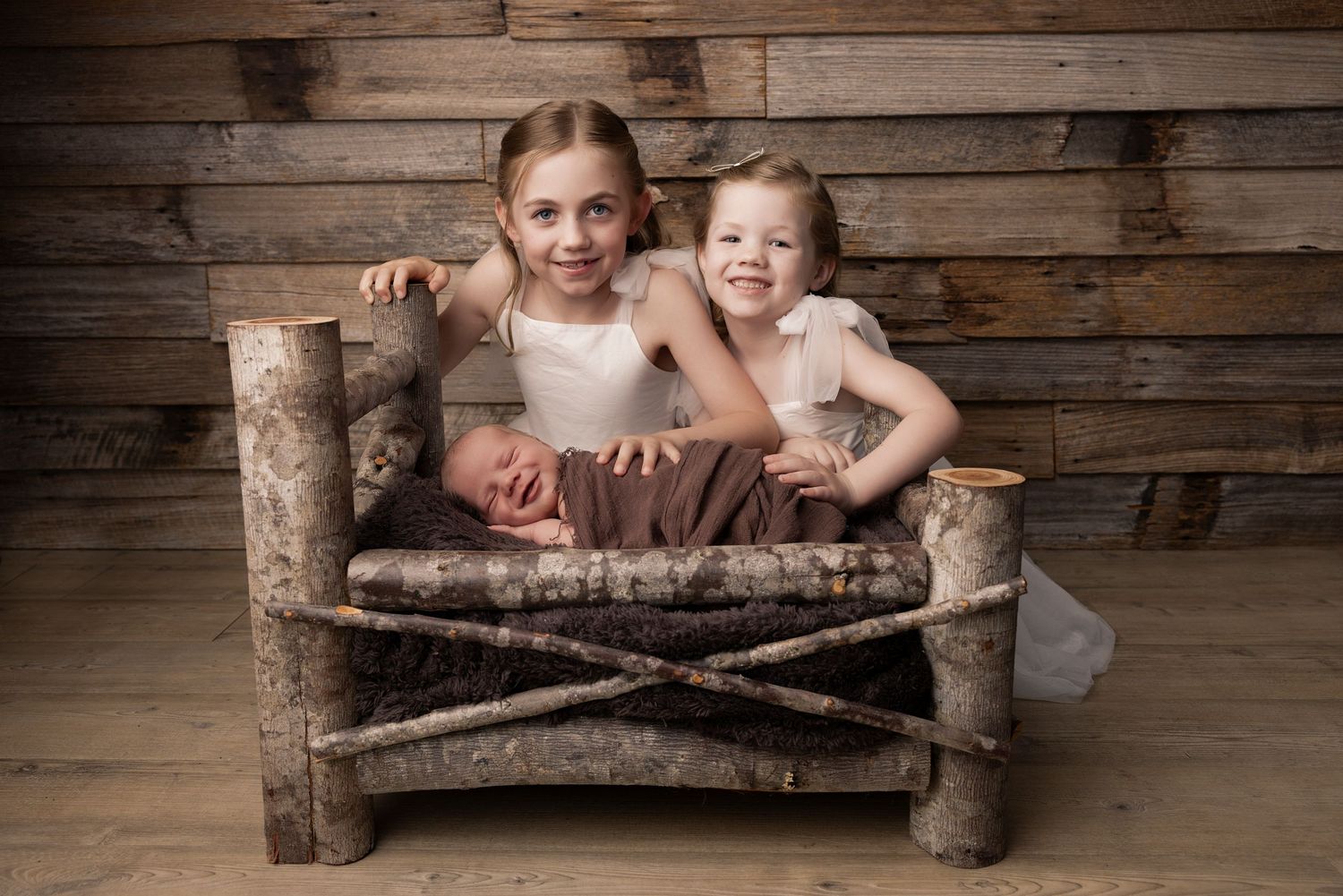 Children lounging casually on rustic log benches with wooden plank backgrounds.