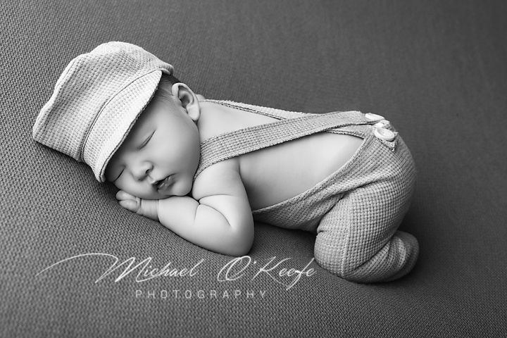Black and white artistic newborn photography collage showing peaceful sleeping baby in soft poses and wraps.