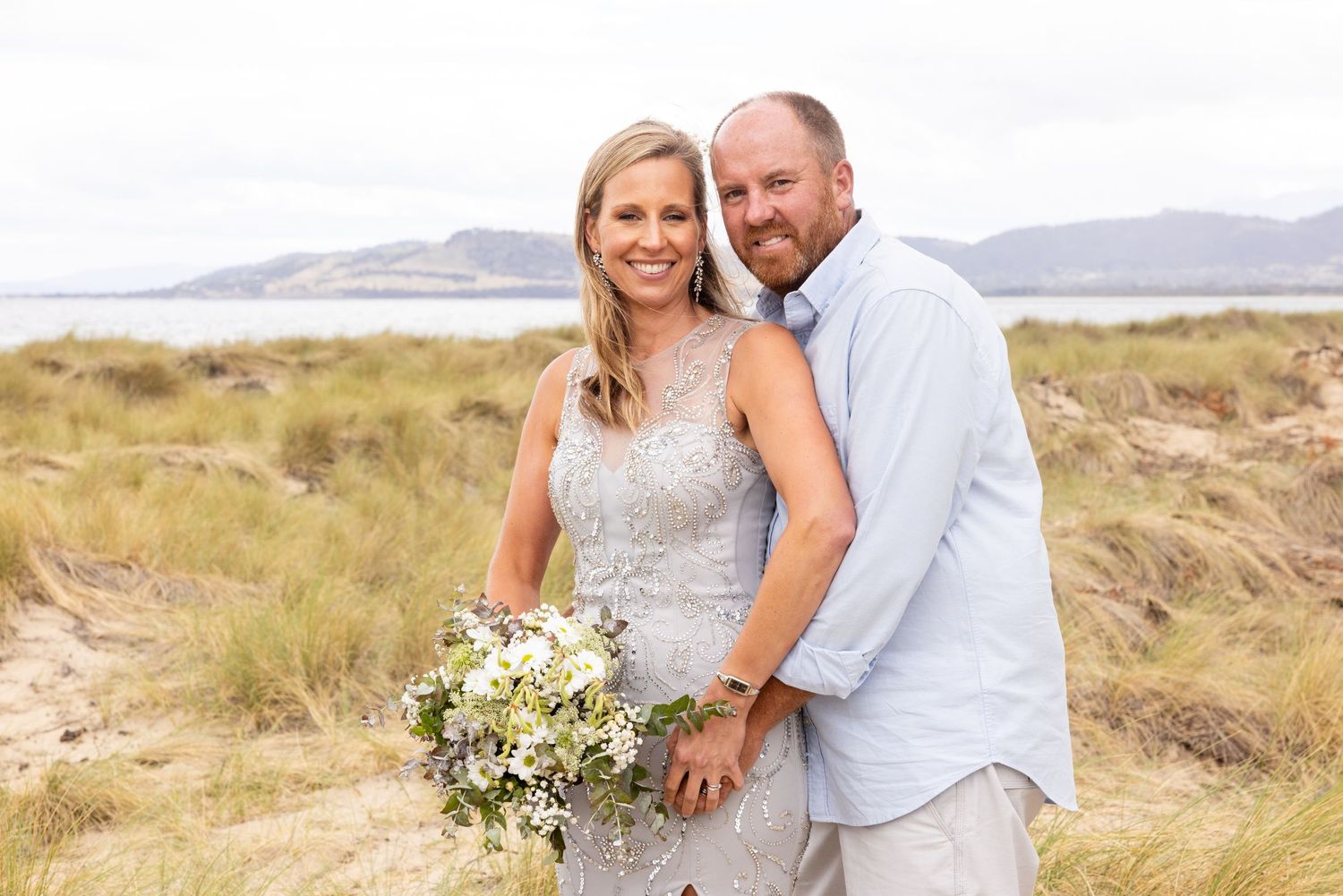 A romantic beach wedding photo sequence showing a couple embracing against a desert landscape.