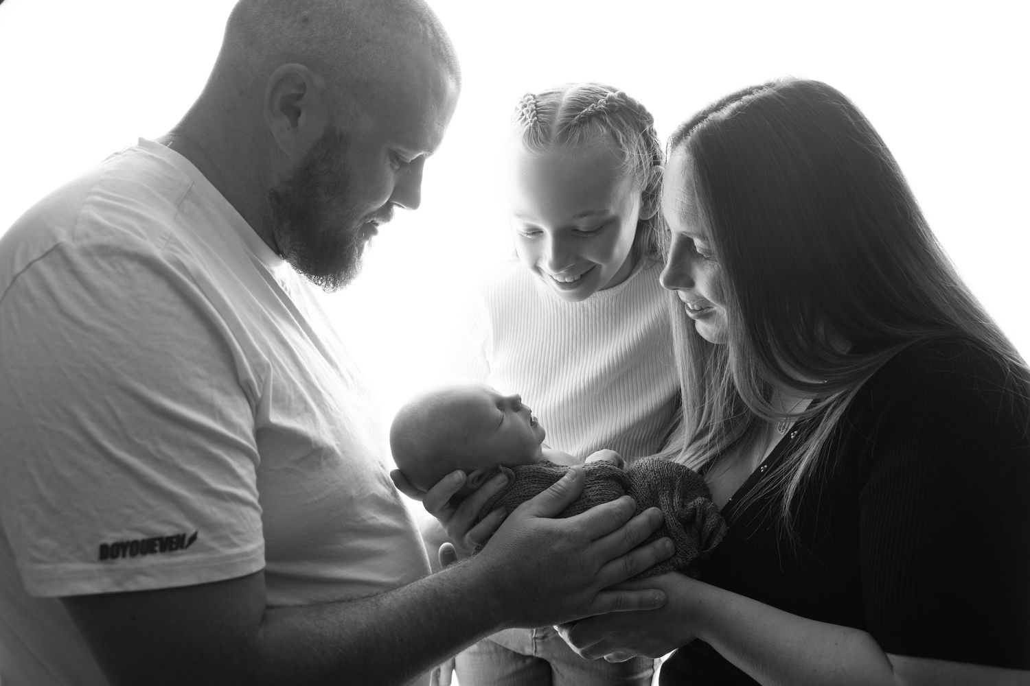 Black and white emotional family portraits showing tender moments.
