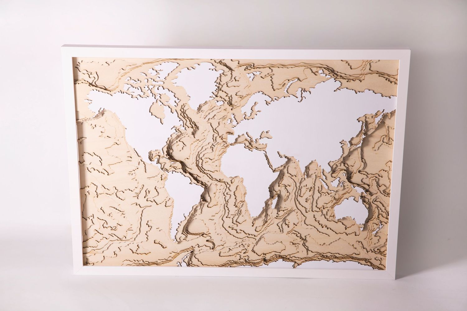 3D wooden world map showing topographical relief details and continents.