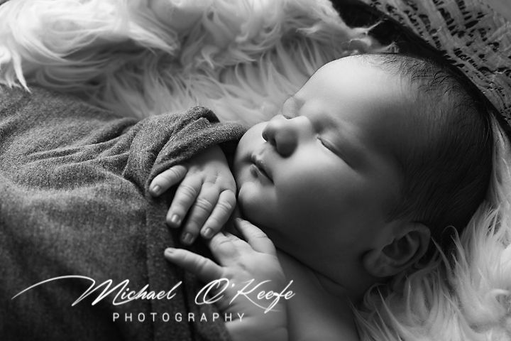 A black and white artistic newborn photography banner shows multiple connected images of sleeping infants.