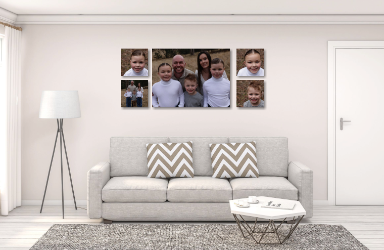 Modern living room interior with grey couch, chevron pillows, and family photos displayed on wall above sofa.
