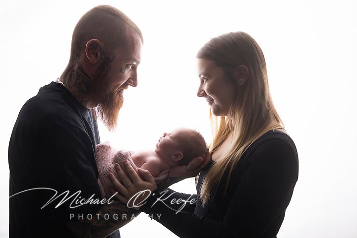 A collection of intimate silhouettes showing tender family moments in black and white photography against a white backdrop.