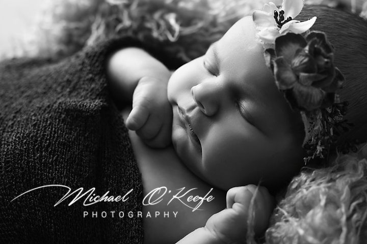 Black and white artistic closeup photo showing gentle facial features with a graceful delicate pose.