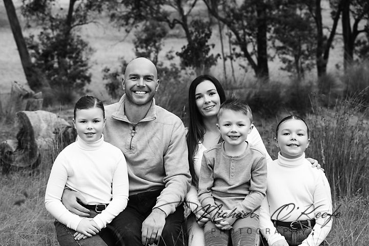 Relaxed family lifestyle session captured in woodland setting during golden hour.