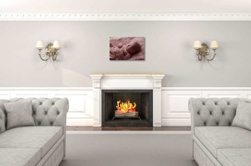Elegant living room with grey tufted sofas, wall sconces, and fireplace with burning flames.