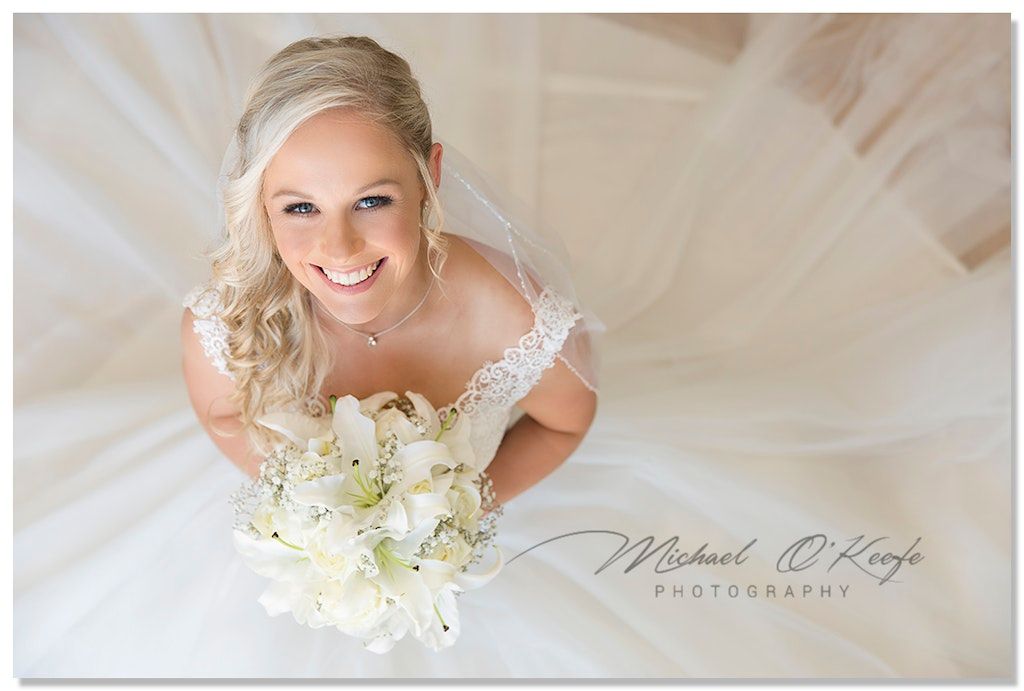 Elegant bridal portraits featuring white flowers and flowing wedding dress details.