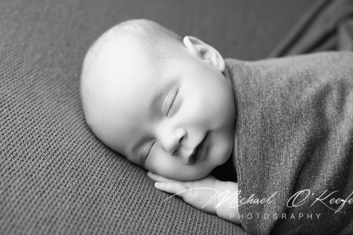 Black and white collage showing peaceful sleeping baby in various close-up poses on soft textured fabric.