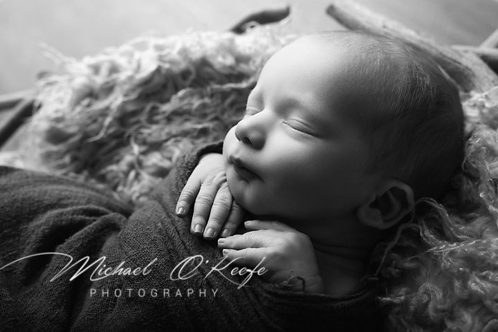A series of black and white artistic newborn photography portraits showing peaceful sleeping poses and delicate details.