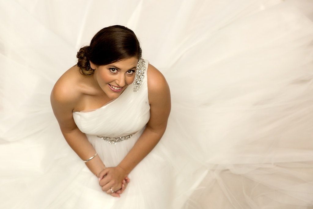 Artistic bridal portraits showing close-up details of a white wedding dress.