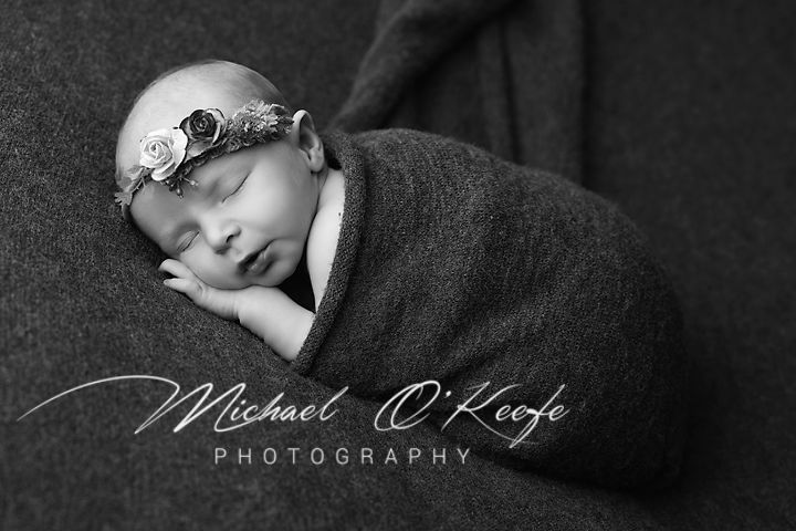 Black and white artistic portrait photography with dramatic lighting and shadows.