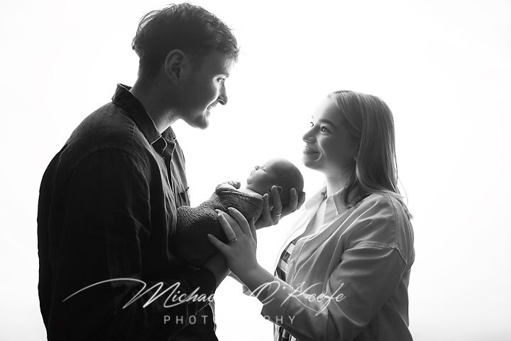 Black and white romantic silhouette of a couple embracing in a tender moment during their wedding photoshoot.