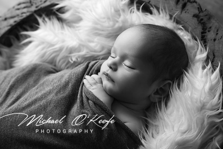 Black and white artistic newborn photography collage with white fur and soft lighting effects.