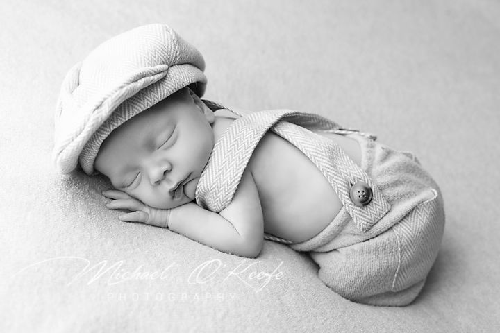 High key black and white newborn photography series showing baby in various sleeping positions on white backdrop.