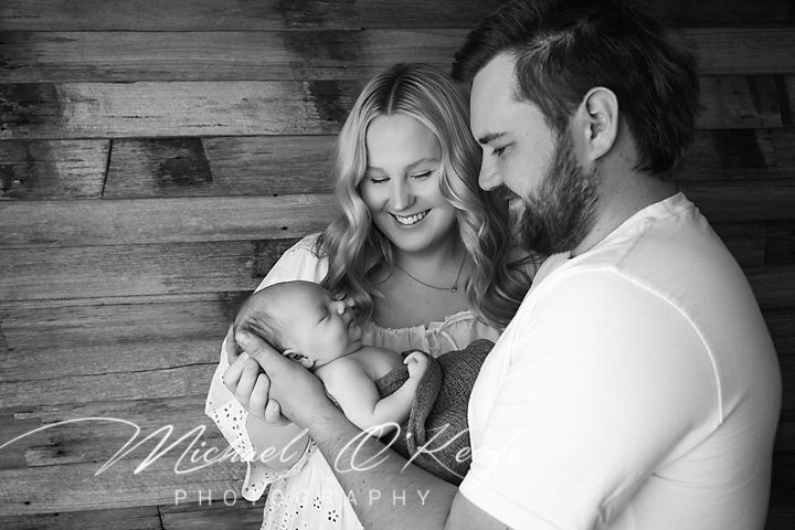 A series of intimate black and white maternity photos showing tender moments between expectant parents.