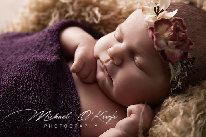 A collection of soft focus newborn photography portraits showcasing peaceful sleeping poses against dark backgrounds.