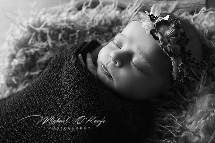 A series of black and white artistic portraits showing someone reclining with ethereal flowing fabric and dramatic lighting.